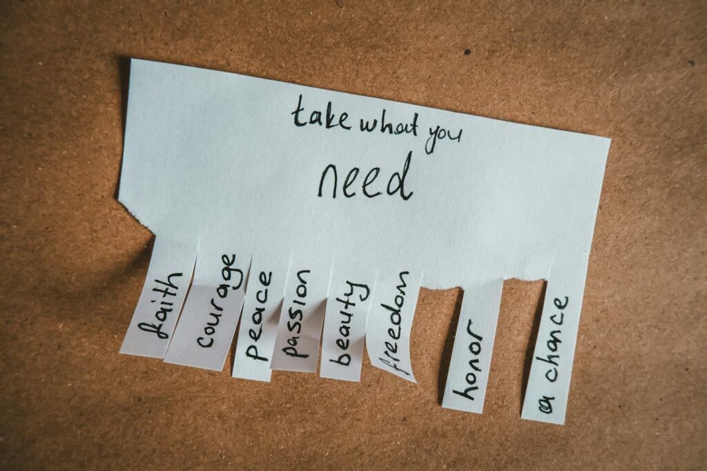 Inspirational handwritten note with virtues on tear-off tabs for personal growth.