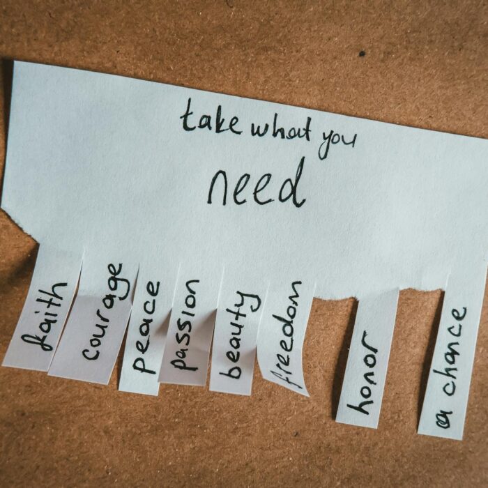 Inspirational handwritten note with virtues on tear-off tabs for personal growth.